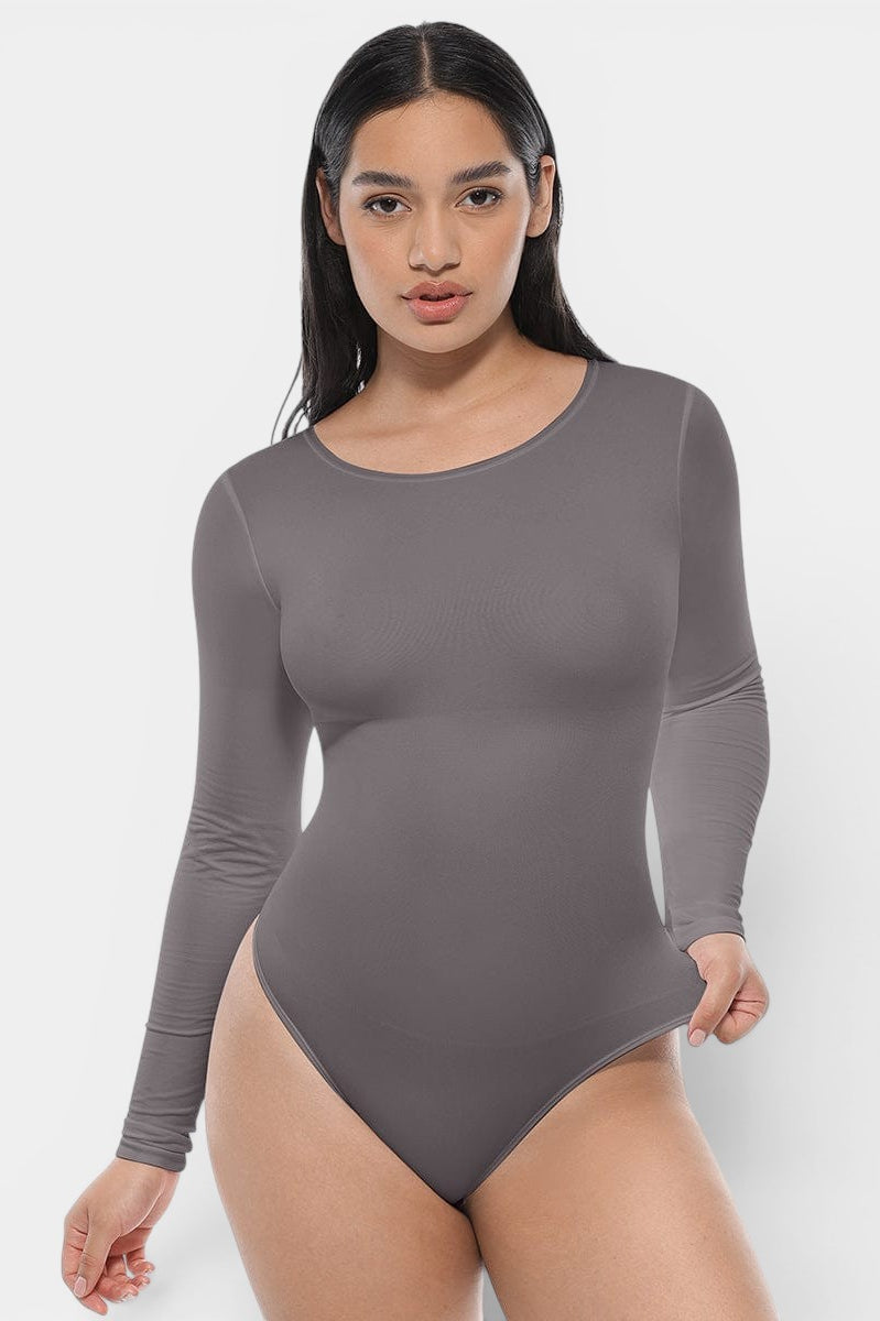 www.modusactive.com white long sleeve bodysuit with tummy and arm slimming features, made of nylon and spandex.