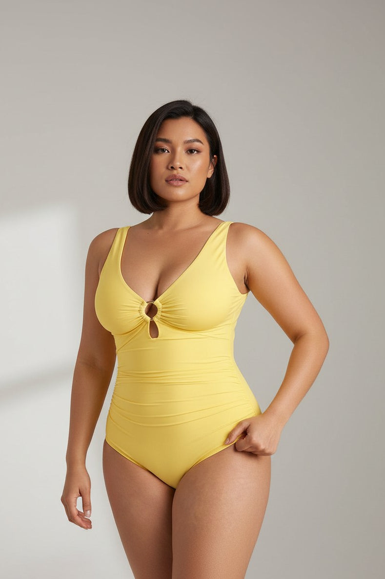 MODUS Swim™ yellow ruched V-neck one-piece swimsuit with gold ring detail and wide straps. Nylon/Spandex blend.