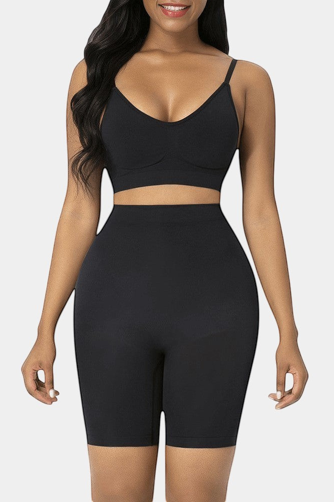Black seamless high-waist butt lifter shorts made of nylon and elastane, designed for tummy control and slimming.