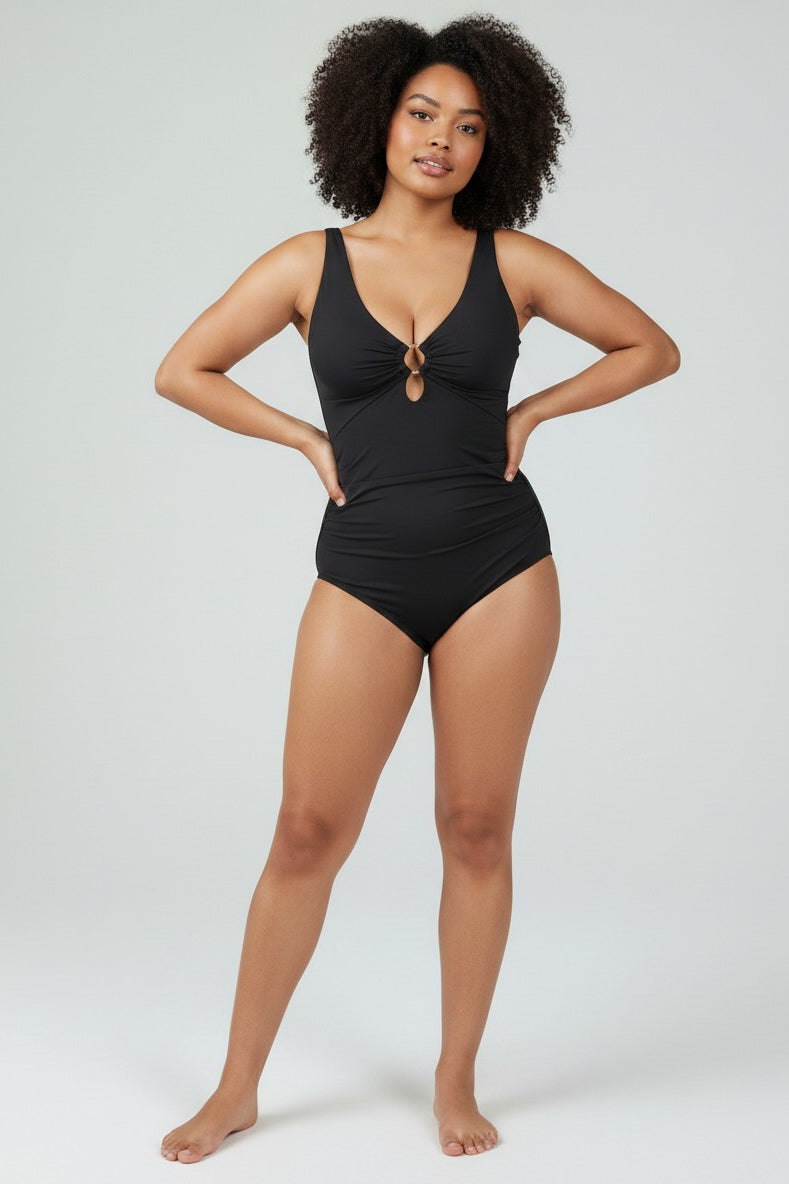www.modusactive.com black ruched V-neck one-piece swimsuit with gold ring detail and wide straps.