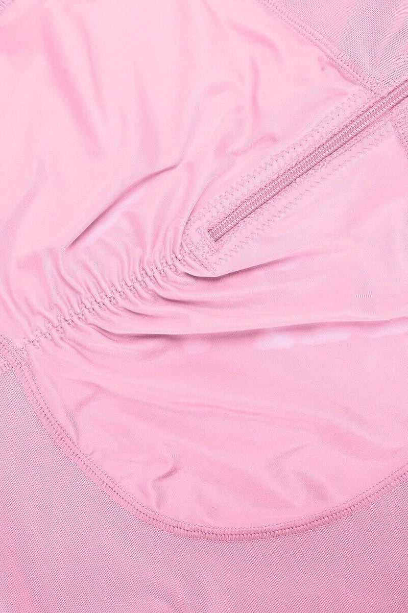 www.modusactive.com pink nylon and spandex bodysuit with triple closure, ruched front, and mesh panels.
