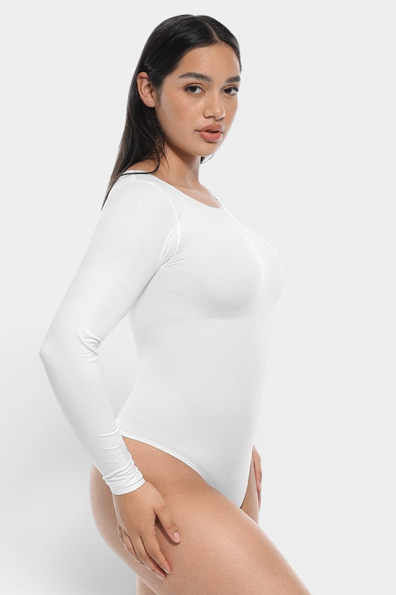www.modusactive.com white long sleeve bodysuit made of nylon and spandex with tummy and arm slimming features.