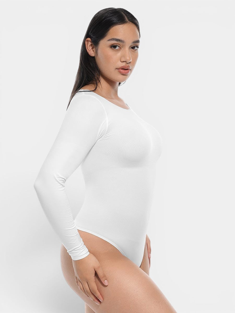 www.modusactive.com white long sleeve bodysuit made of nylon and spandex with tummy and arm slimming features.