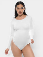 www.modusactive.com white long sleeve bodysuit with tummy and arm slimming features, made of nylon and spandex.